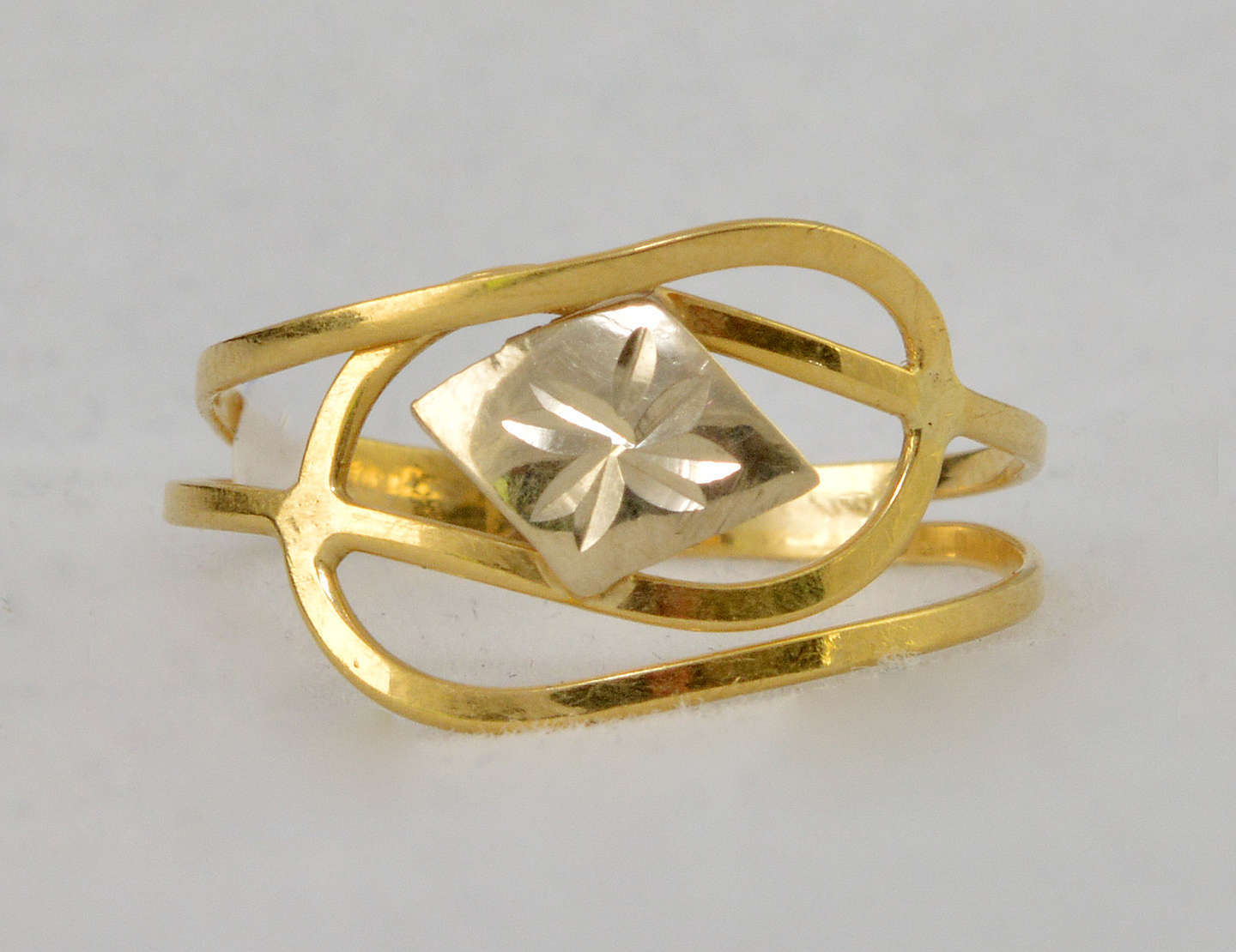 Anel em ouro 18 k decorado com flor central em ... - Anel em ouro 18 k decorado com flor central em ouro branco rodinado, Aro 15 e peso aproximado 0.9 g. Anel em ouro 18 k decorado com flor central em ... - Anel em ouro 18 k decorado com flor central em ouro branco rodinado, Aro 15 e peso aproximado 0.9 g.