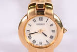 Relógio Seiko feminino, pulseira dourada, em al... - Relógio Seiko feminino, pulseira dourada, em algarismos romanos, na caixa.