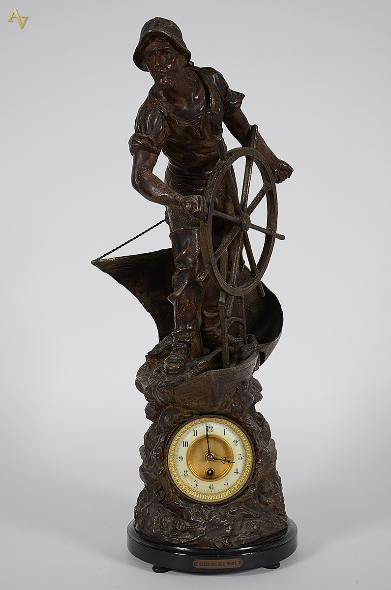 Escultura em petit bronze com relógio "Steering for home"... - foto 1 de 3