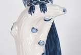 Estatueta de porcelana azul e branca representa... - Estatueta de porcelana azul e branca representando pássaro no galho.