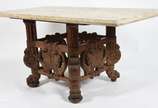 Mesa de madeira nobre com pé em florões ricamen... - Mesa de madeira nobre com pé em florões ricamente entalhados, arremates inferiores de metal,  tampo de mármore Bege Bahia fosco.