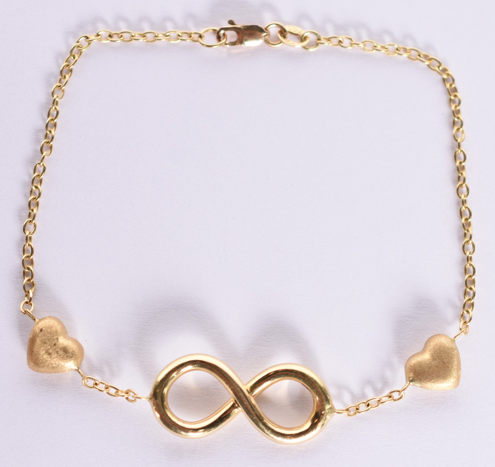 Pulseira de ouro 750 com detalhe feitio "infinito" e corações. (Por... - foto 1 de 3