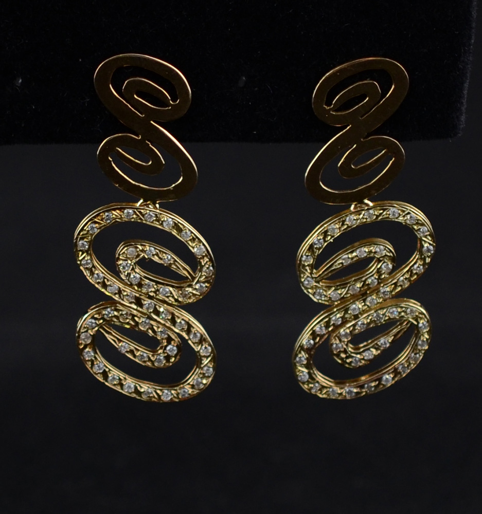 Par de brincos em ouro 18k, forma de onda c/ diamantes. Peso:9g.