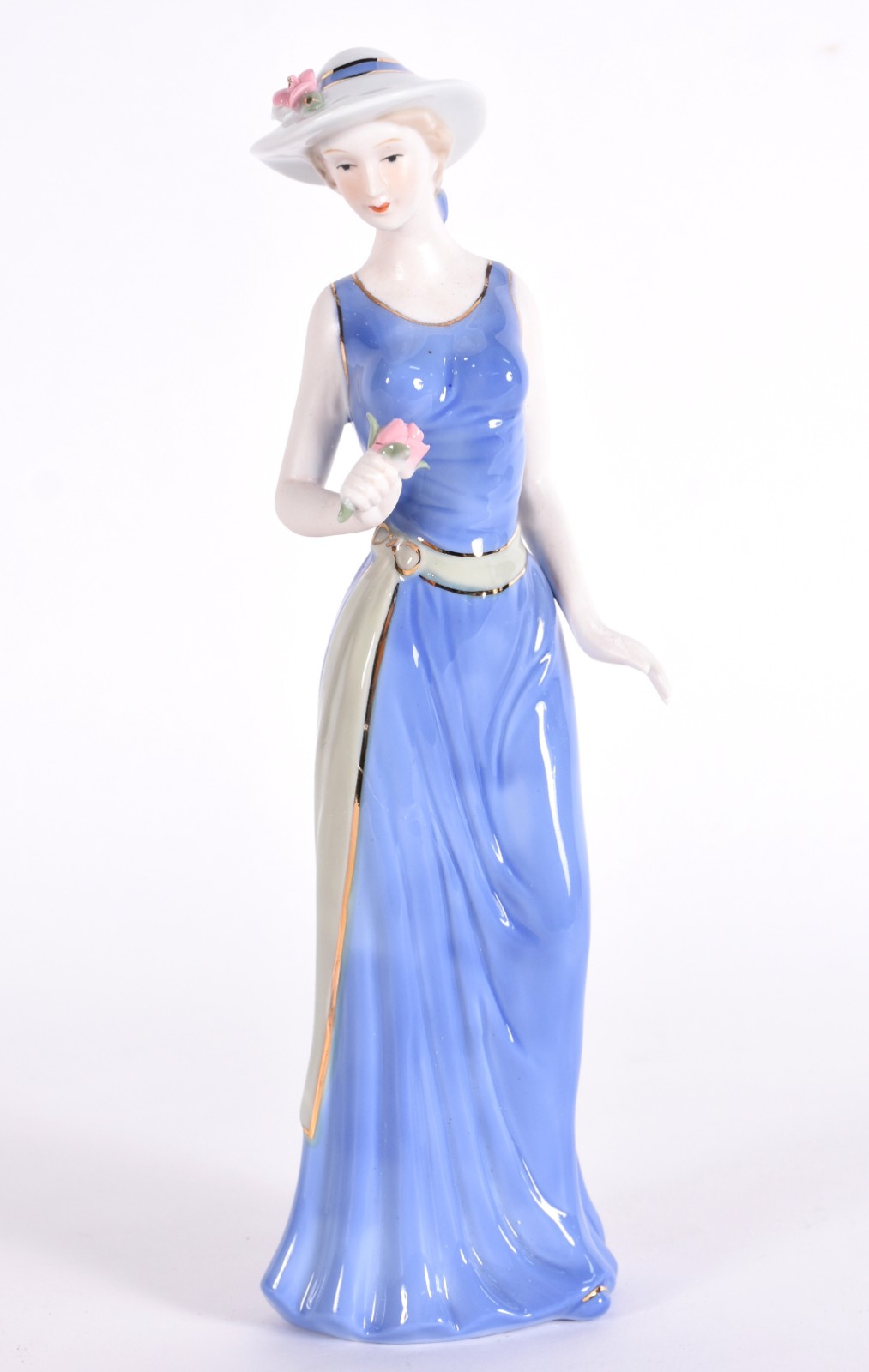 Escultura de porcelana representando dana com chapéu. - foto 1 de 5