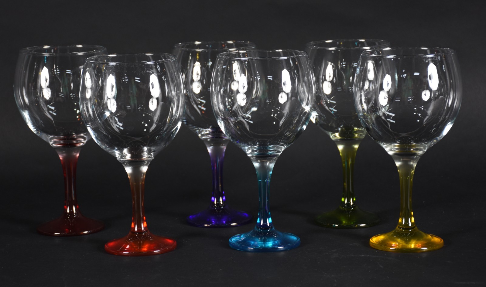 Seis taças para vinho de vidro feitio balloon com pés coloridos. - foto 1 de 4
