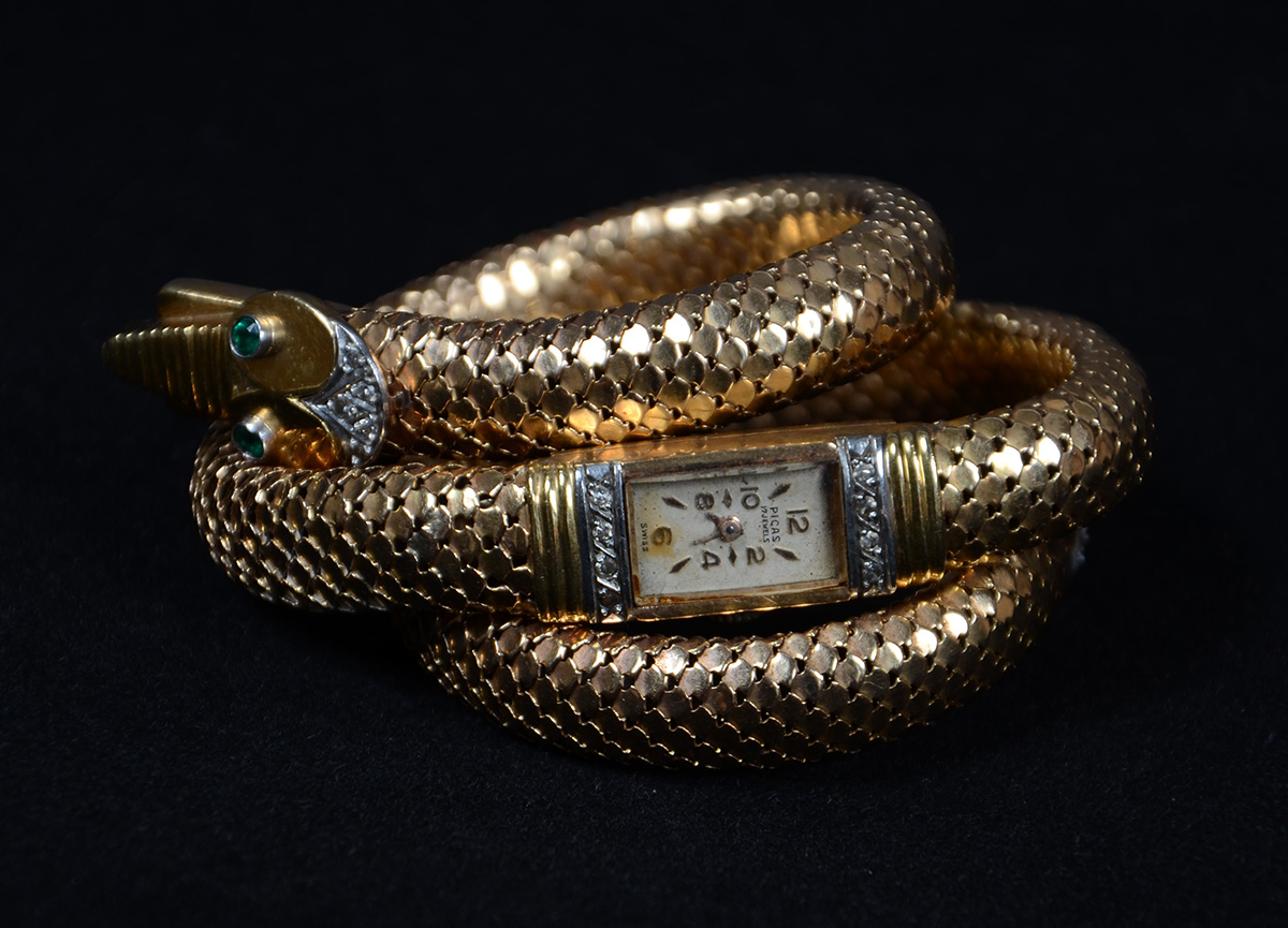 Relógio-pulseira de ouro 18 k em forma de cobra e pedras verdes e... - foto 1 de 3