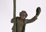 A.DE RANIERI (1880-1914),  - Três peças, sendo: abatjour de metal com figura de menino com boné assinado A.de Ranieri (d'après);  escultura de madeira representando menino com cân