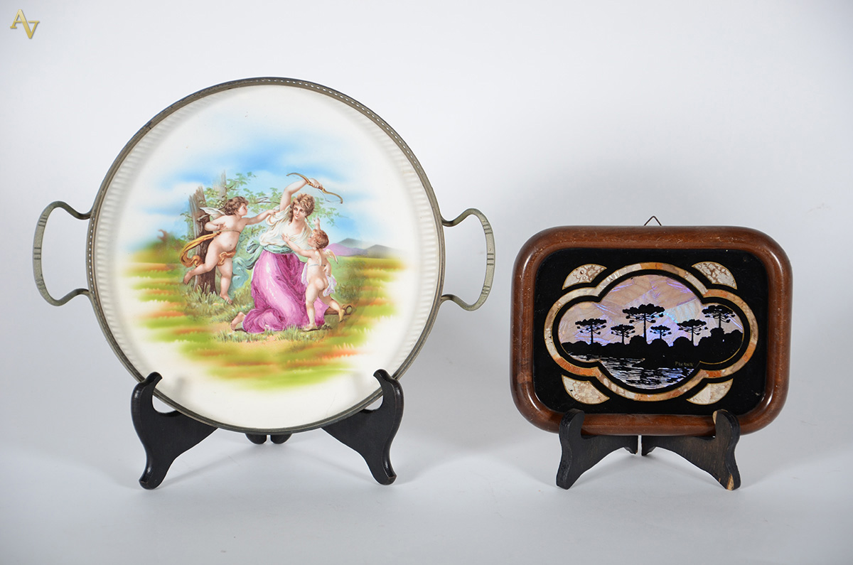 Duas bandejas, sendo 1 redonda de porcelana com cena de mulher e...