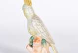 Escultura de porcelana representando cacatua em... - Escultura de porcelana representando cacatua em policromia.