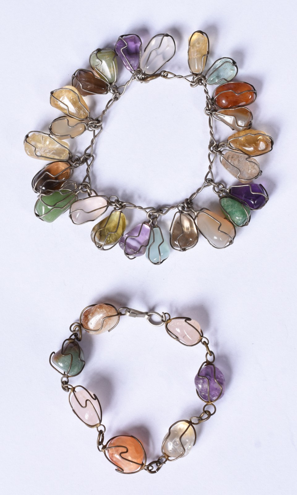 Duas pulseiras, sendo uma de prata e outra de metal com pedras... - foto 1 de 7