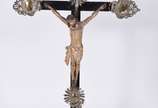 Crucifixo de madeira nobre com figura de Cristo... - Crucifixo de madeira nobre com figura de Cristo ricamente entalhada.(Resplendor faltando partes, e metal com desgastes).
