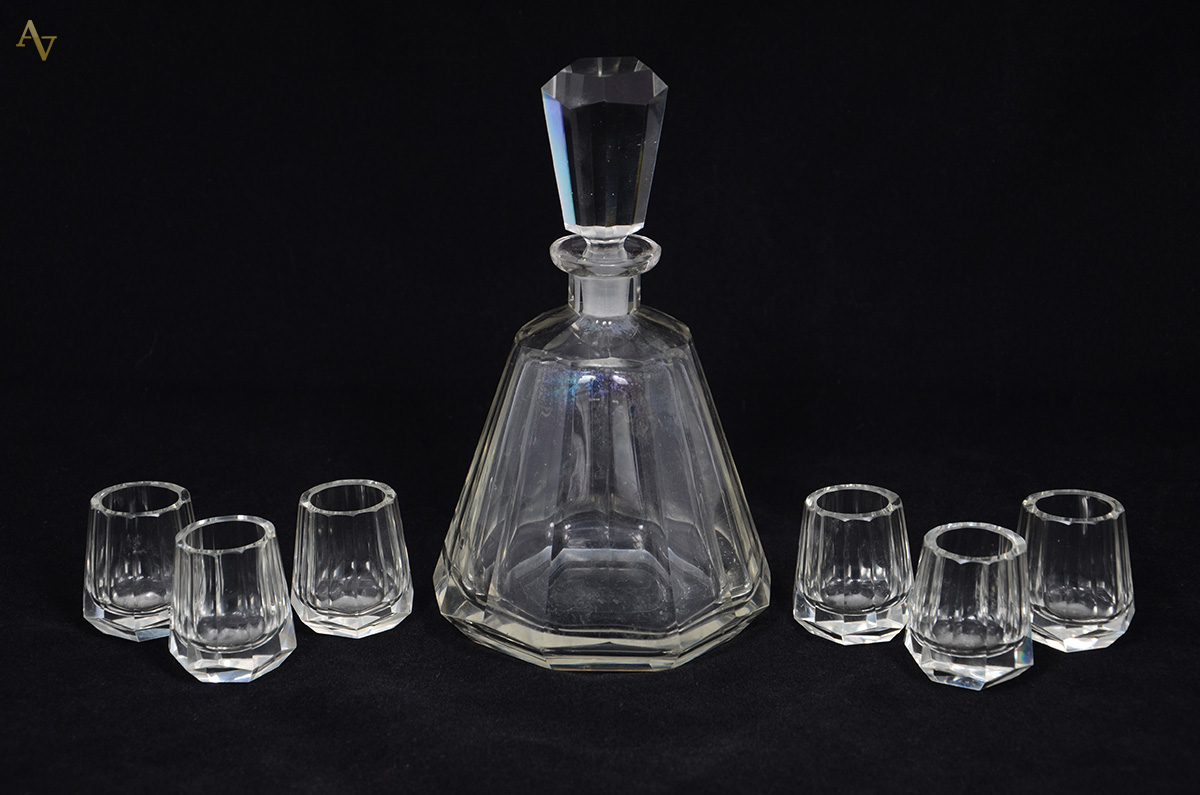 Licoreira de cristal tcheco facetado com seis copinhos. Altura 21 cm.