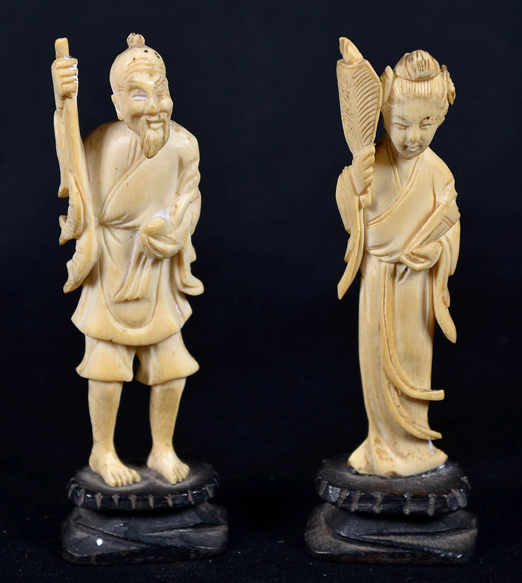 Duas estatuetas de marfim representando casal de anciãos. Alt. 12 cm.