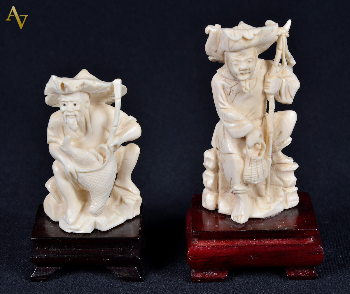 Dois netsukes, sendo figuras com cajado e base de madeira. Alt. 6 e 8...