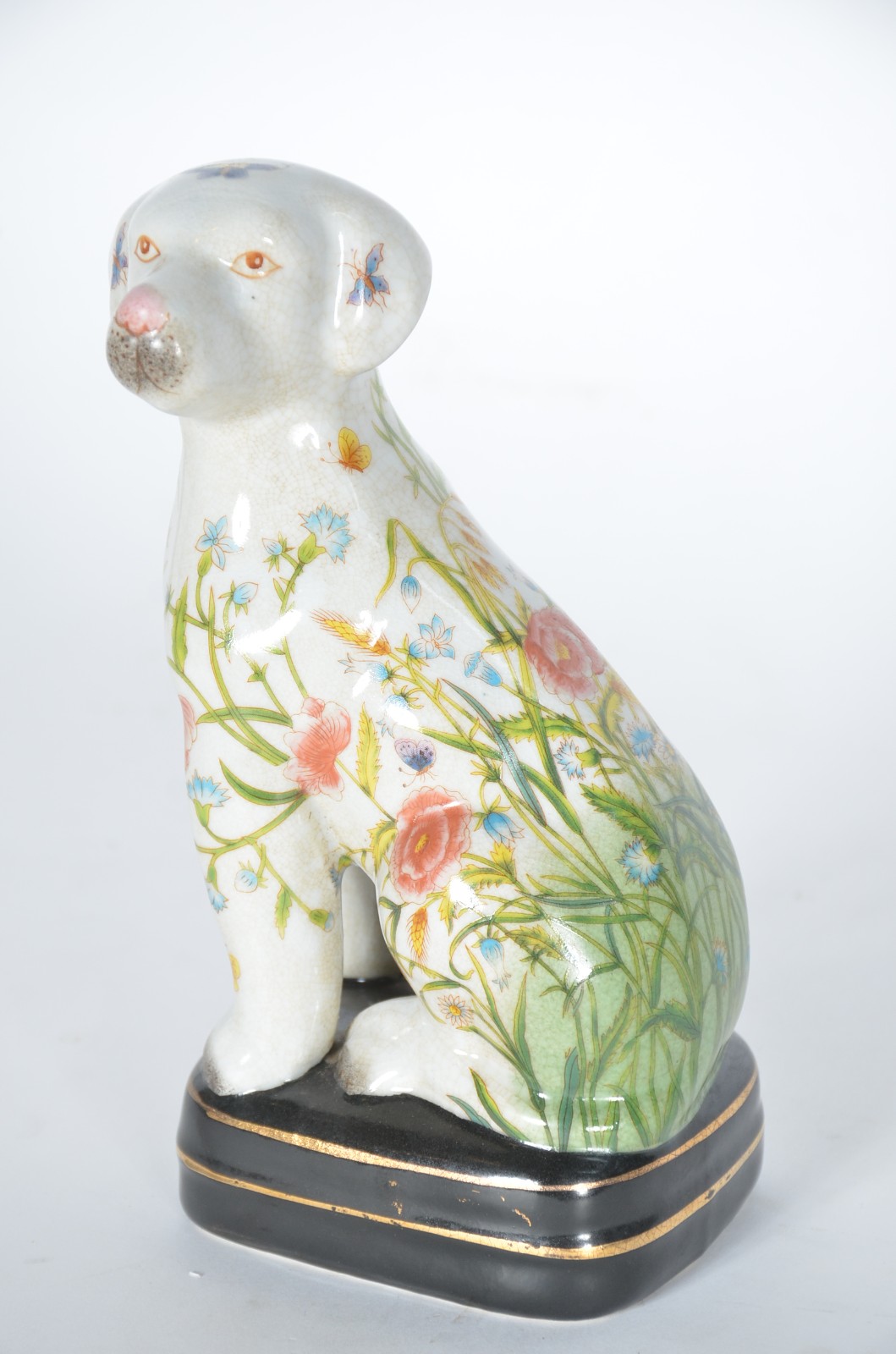 Estatueta de cerâmica representando cachorro com folhagens e flores... - foto 1 de 7