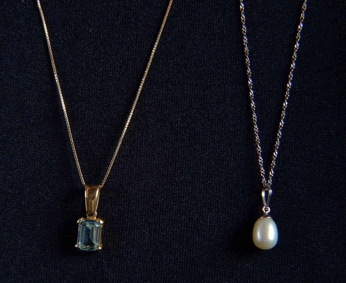 Dois cordões de ouro 18 k com pedra azul e pérola.