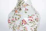 Vaso de porcelana branca com folhagens e flores... - Vaso de porcelana branca com folhagens e flores em policromia.
