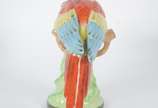 Estatueta de porcelana policromada representand... - Estatueta de porcelana policromada representando papagaio.