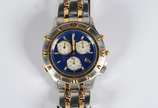 Bulova (1875),  - Relógio masculino com cronógrafo, modelo marina Star, calendário, pulseira e caixa em aço com detalhes dourados, fundo azul. (Por motivos de segurança