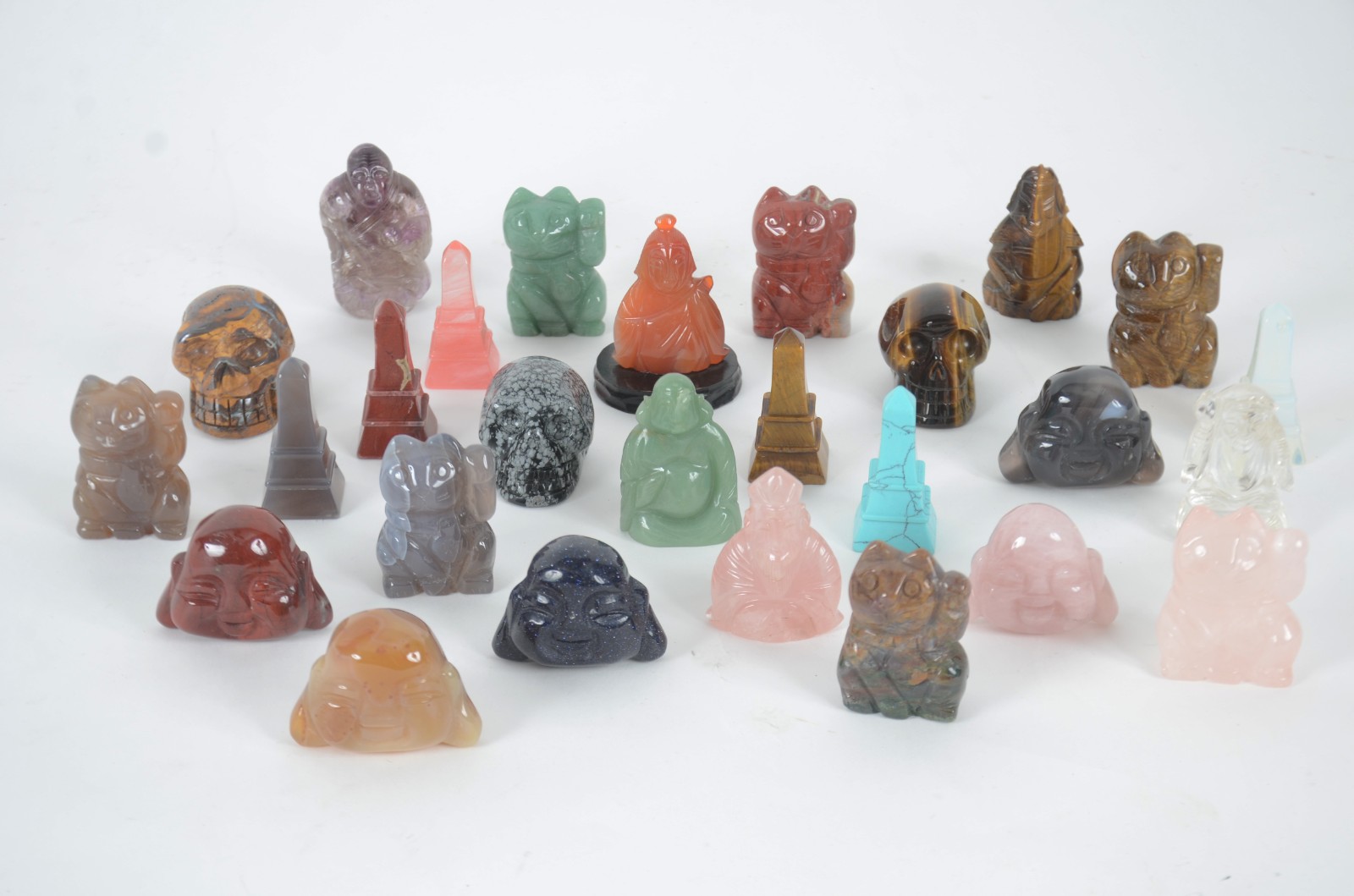 Lote com 27 peças diversas, sendo: 3 caveiras; 6 obeliscos, 5 budas... - foto 1 de 5