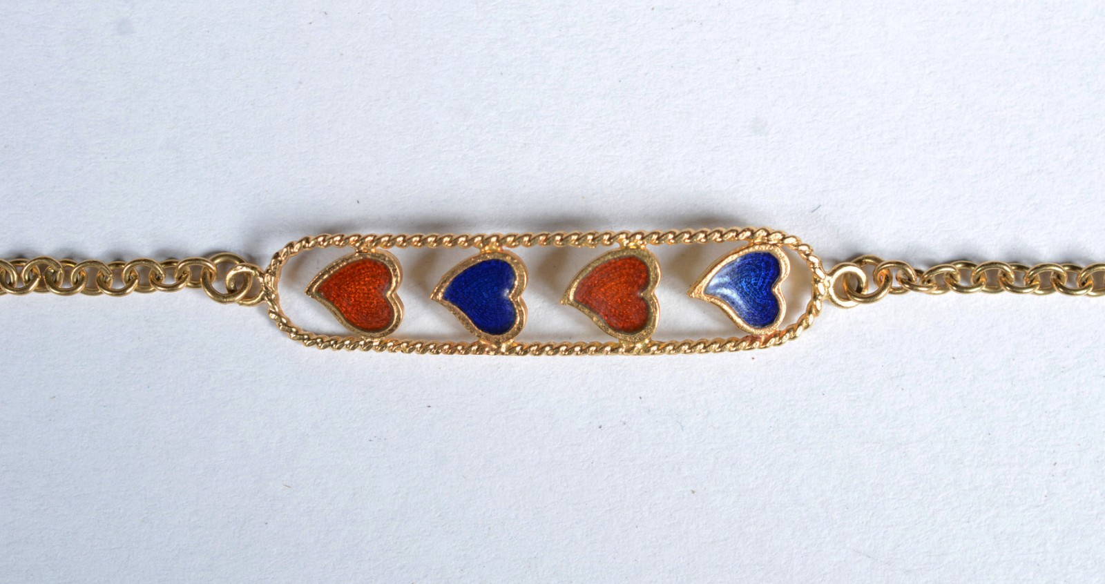 Pulseira de ouro 18 k., placa com 4 corações esmaltados. (Por motivos... - foto 1 de 6
