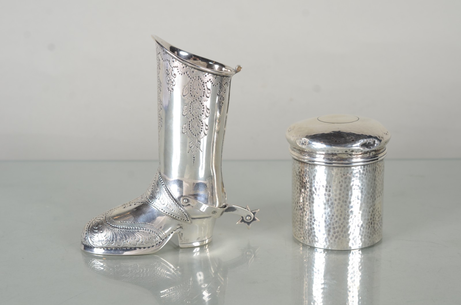 Duas pequenas peças de prata contrastada, sendo: bota trabalhada com... - foto 1 de 9