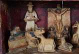 Antigo oratório em nicho de madeira com resquíc... - Antigo oratório em nicho de madeira com resquícios de policromia e figuras esculpidas em pedra sabão. Minas, século XIX.