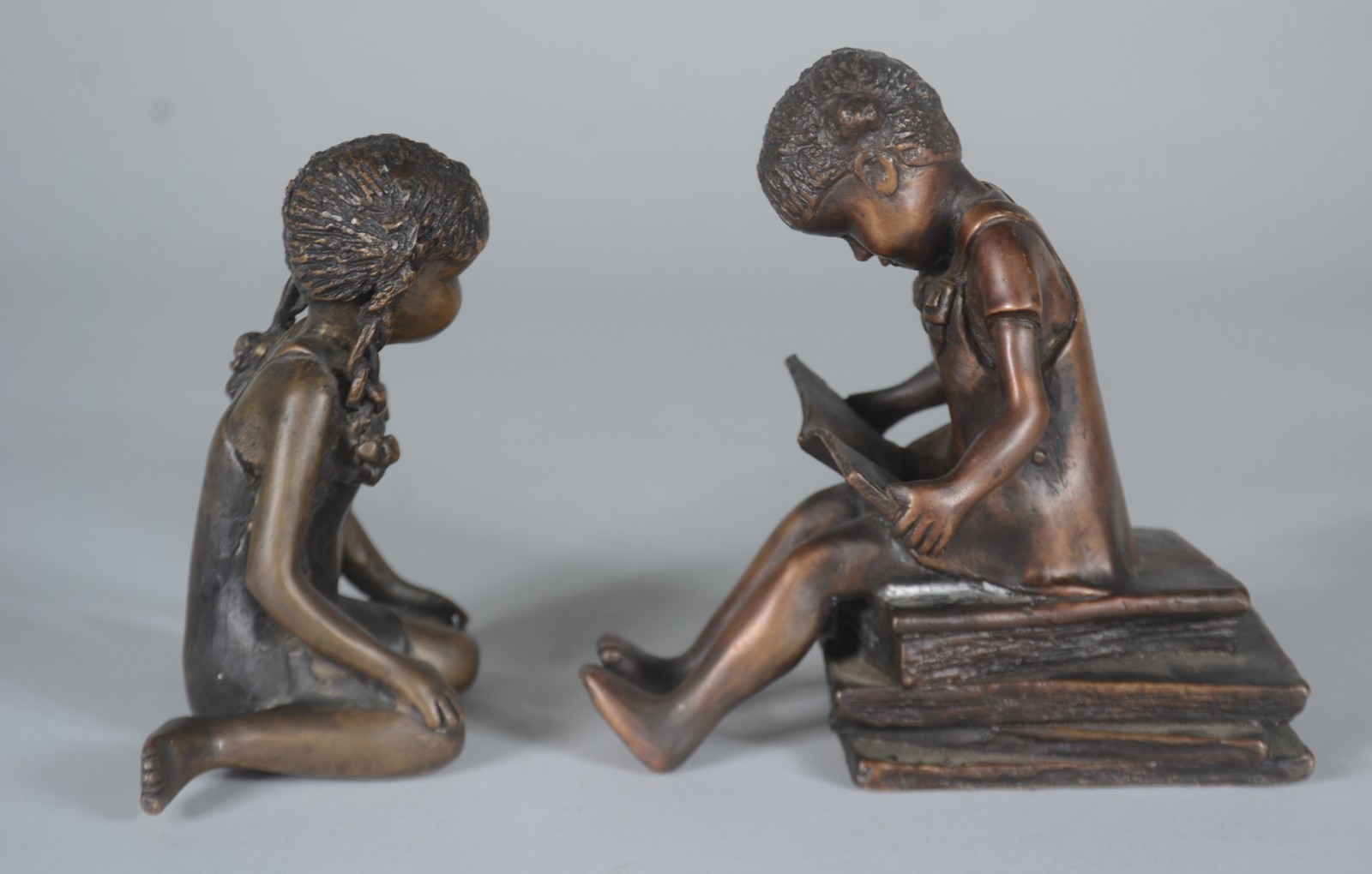 Duas esculturas de bronze representando meninas com livros, uma delas... - foto 3 de 6