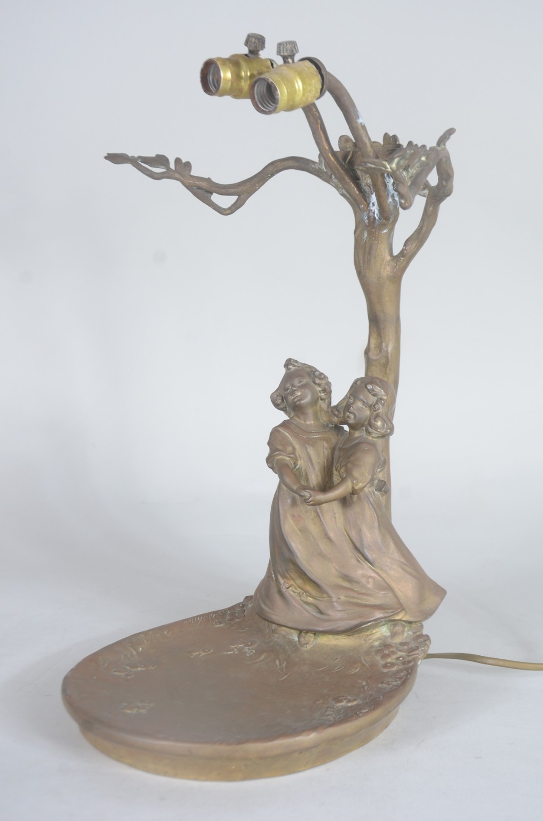 Luminária de bronze com figuras de crianças sob árvore. Faltando as... - foto 2 de 8