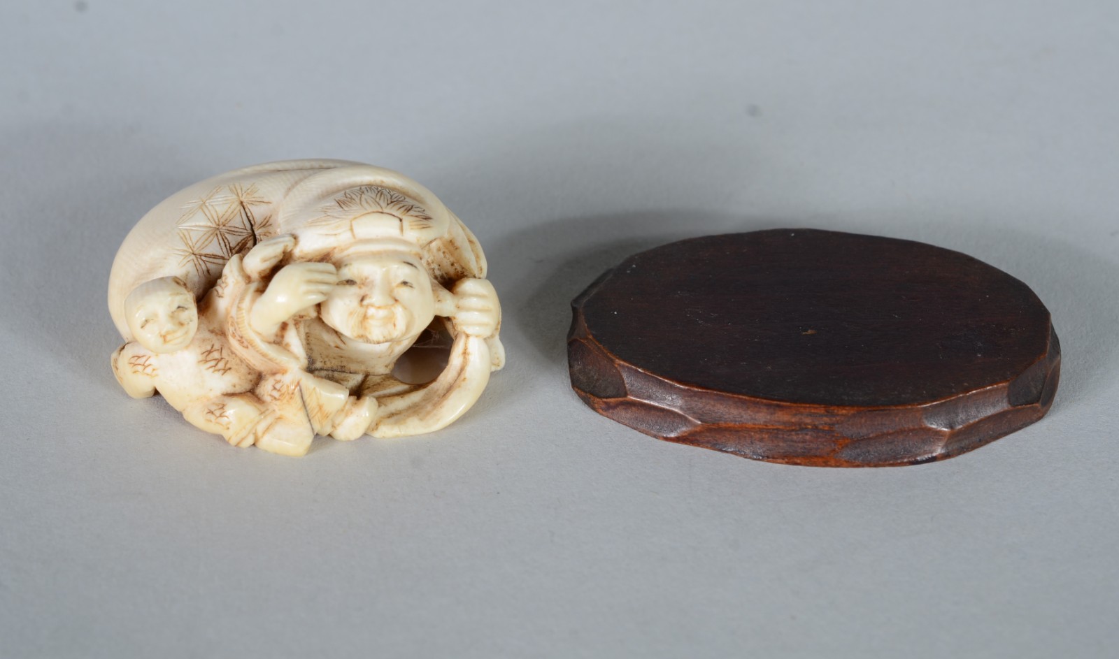 Netsuke de marfim representando figura típica com criança, base de... - foto 2 de 5
