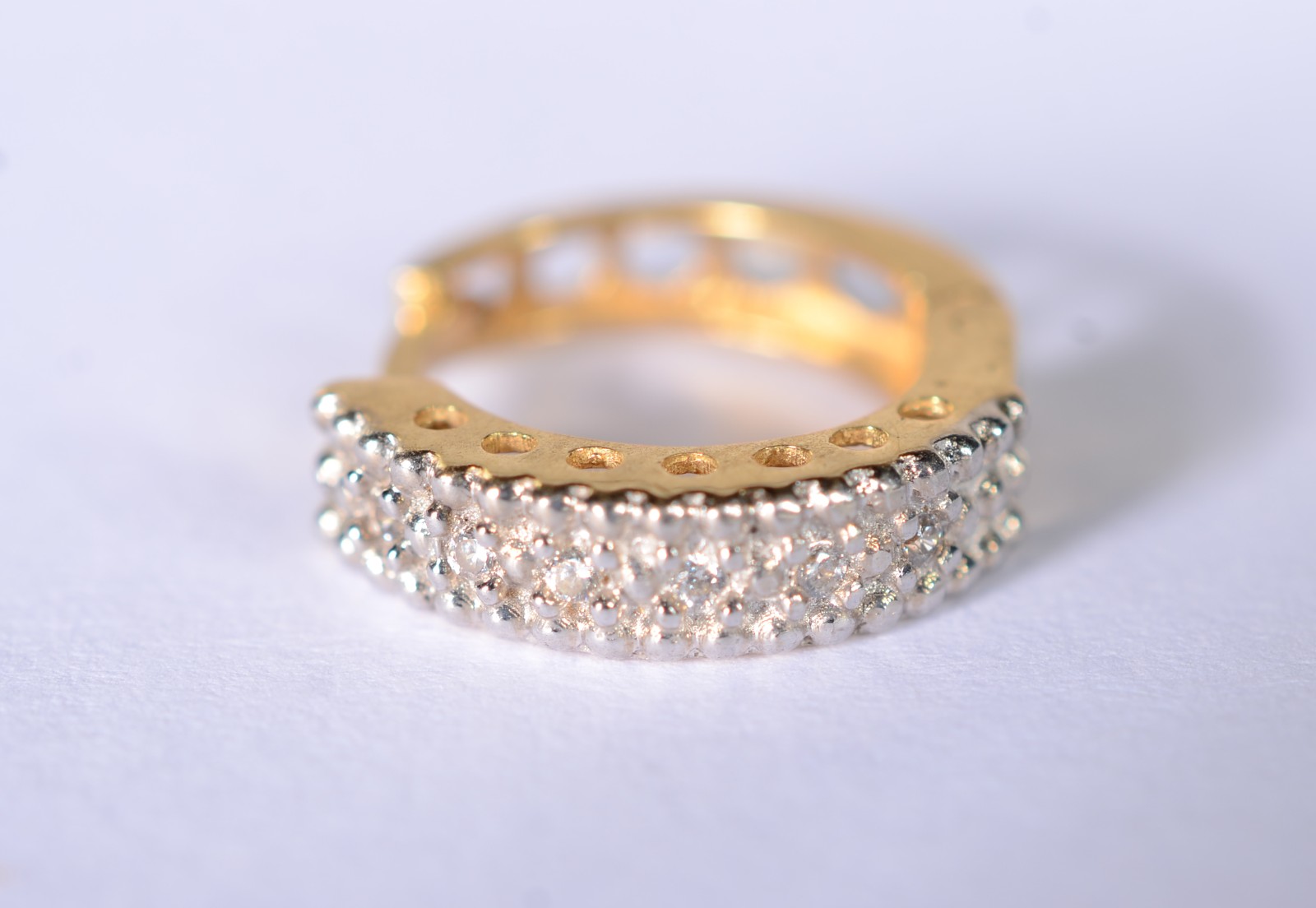 Um brinco de ouro 18 k., contraste 750 mls com safiras brancas. (Por... - foto 1 de 6