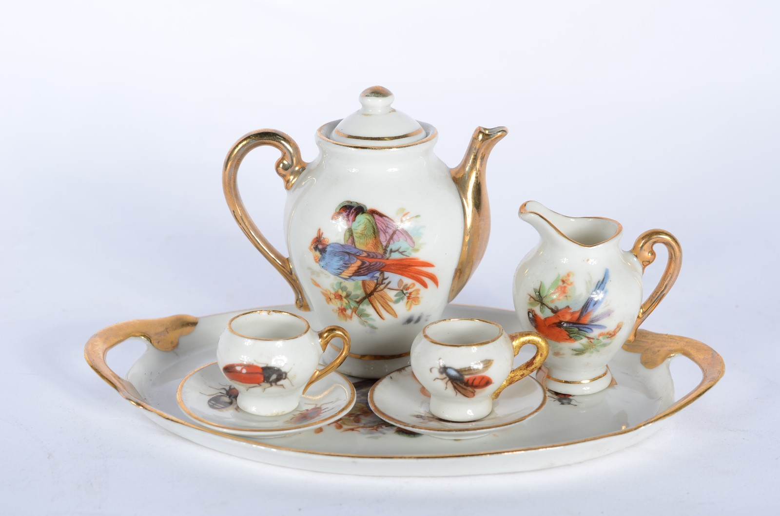 Três conjuntos de tete a tete em miniaturas de porcelana no total de... - foto 2 de 11