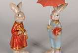 Duas esculturas de porcelana policromada repres... - Duas esculturas de porcelana policromada representando casal de coelhos.