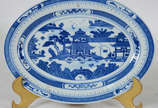 Pequena travessa de porcelana oriental decorada... - Pequena travessa de porcelana oriental decorada com Cenas de paisagem e pagodes em azul e branco (com restauro).