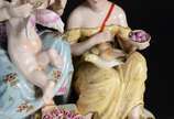 Grupo escultórico de porcelana policromada repr... - Grupo escultórico de porcelana policromada representando figuras femininas com anjo e pomba, marcada na base.