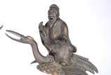 Par de antigas esculturas chinesas em bronze co... - Par de antigas esculturas chinesas em bronze com detalhes dourados, representando Sábios sobre aves Mitológicas. Figuras soltas de encaixe.