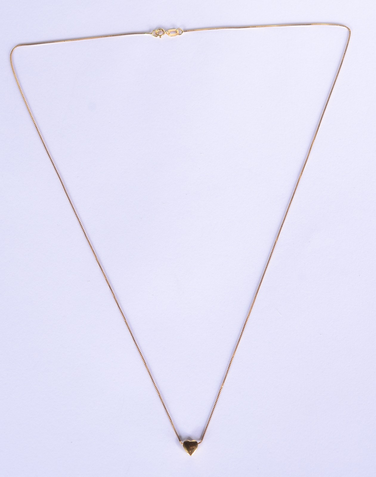 Colar com pendente na forma de coração de ouro 18 k., contraste 750... - foto 2 de 6