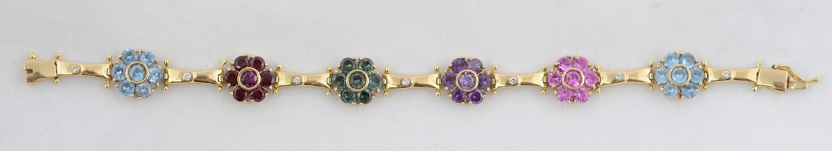 Pulseira de ouro amarelo 18 k com pedras e brilhantes. Peso total 21...