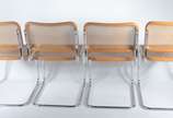 Marcel Breuer (1902-1981),  - Mesa de vidro com base de metal. Acompanham 4 cadeiras “Cesca” com forração em palhinha, design Marcel Breuer  (duas delas com os assentos rasgados).