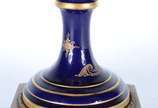 Ânfora de porcelana francesa azul cobalto e dou... - Ânfora de porcelana francesa azul cobalto e dourado, decorada com cena romântica e paisagem em policromia, guarnição de bronze. Ligeiramente inc...
