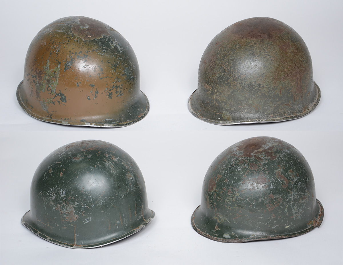 Quatro capacetes militares modelo M1.