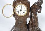 Ansonia Clock Company (1851-2006),  - Relógio americano de mesa de petit bronze, com pátina marrom, estilo ART NOUVEAU. Peça representando figura feminina. Decoração representado garça, fl