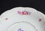 KPM (1831-1971),  - Duas peças de porcelana KPM, sendo uma potiche de porcelana alemã na cor bege com flores em policromia e friso dourado e prato de porcelana polonesa n