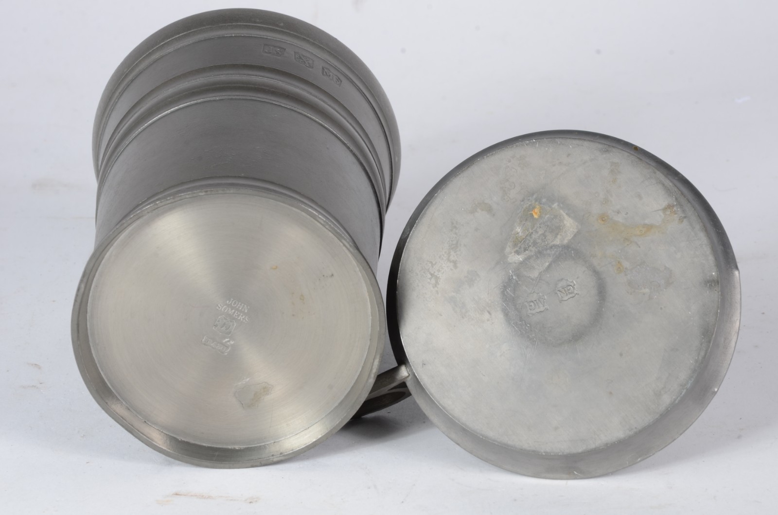 Duas peças de estanho, sendo: vaso John Sommers e uma palmatória. - foto 4 de 6