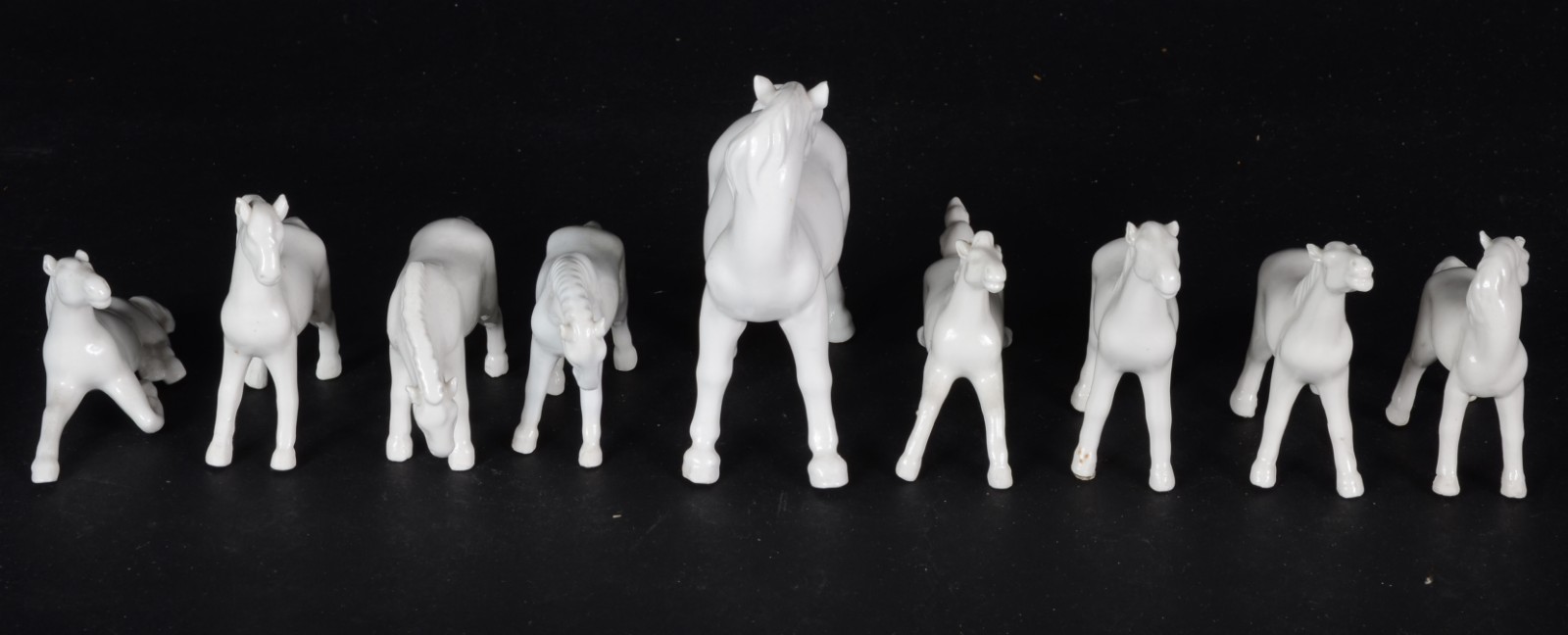 Conjunto com 9 pequenos cavalos de porcelana branca (um com a perna... - foto 2 de 5