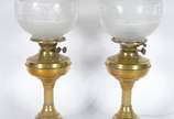 Par de abatjoures de metal dourado, cúpulas na ... - Par de abatjoures de metal dourado, cúpulas na forma de globos de vidro lavrado (uma quebrada). Eram antigos lampiões adaptados para luz elétrica.