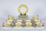 Noritake (1904),  - Serviço para chá e bolo de porcelana Noritake, decorado com guirlandas florais sobre fundo amarelo e alças das xícaras na cor preta, composto de: 12 x