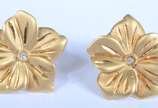 Par de brincos na forma de flor de ouro 18 k., ... - Par de brincos na forma de flor de ouro 18 k., contraste 750 mls  com um brilhante cada. (Por motivos de segurança a peça não se encontra na<br>...