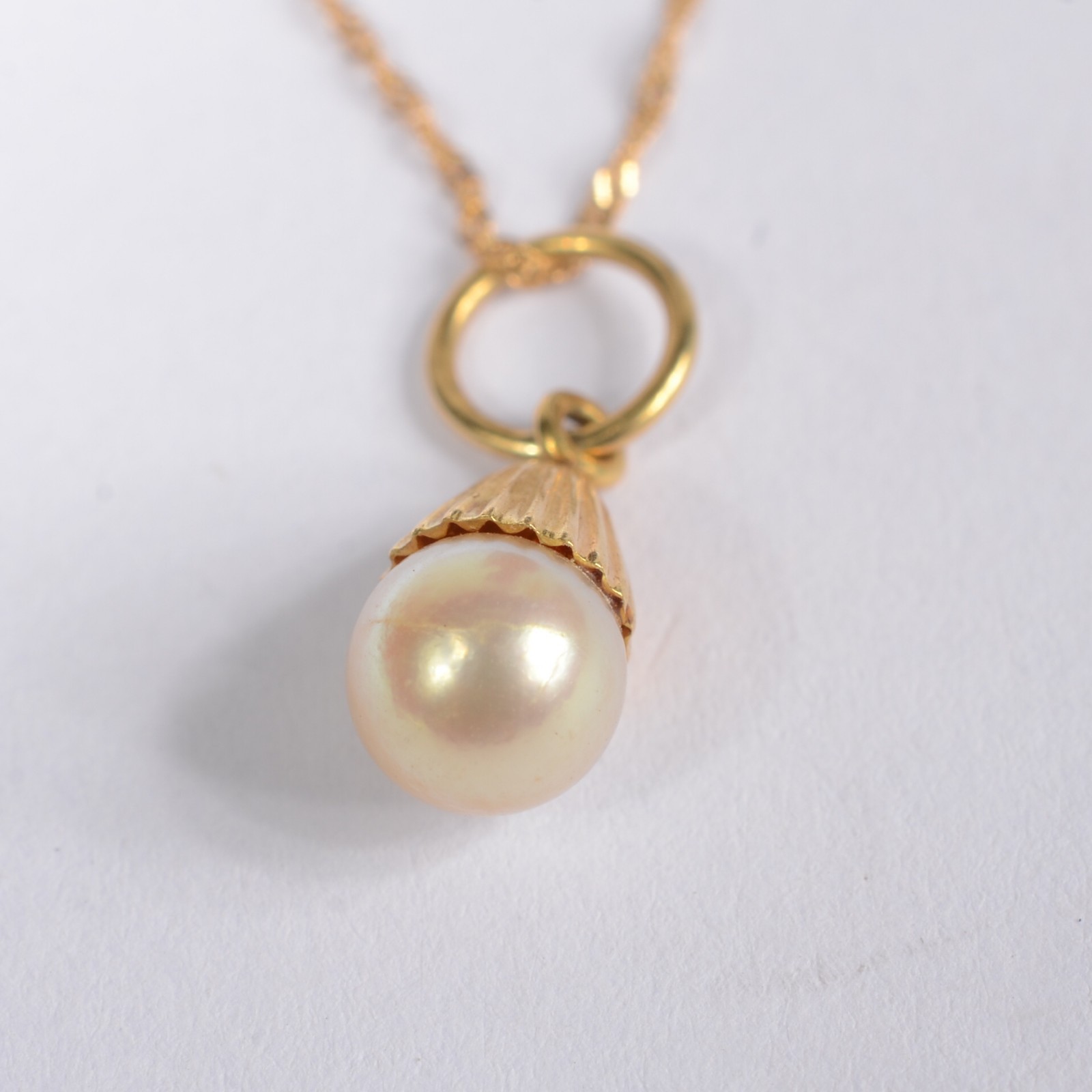 Colar com pendente com uma perola de ouro 18 k., contraste 750 mls... - foto 4 de 7