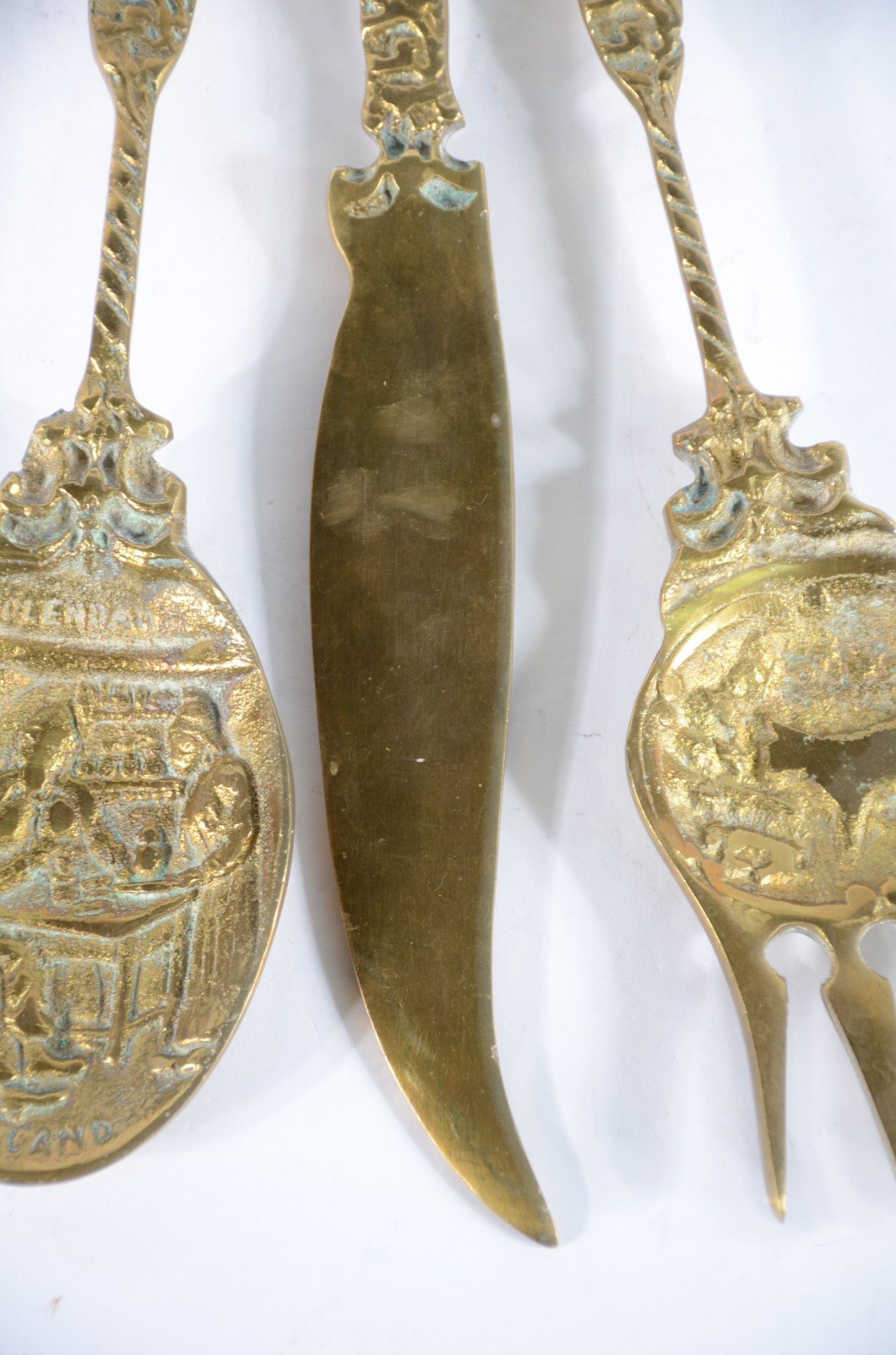 Conjunto com três talheres decorativos de metal dourado com suporte. - foto 4 de 9
